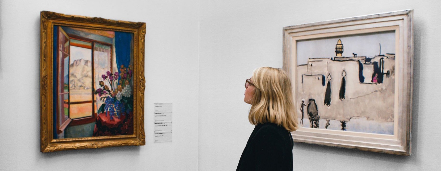 a person looking at art on a wall