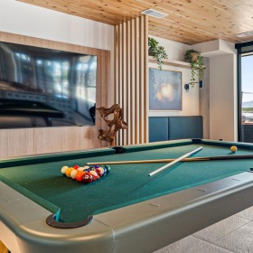 a clubroom with a tv and a pool table