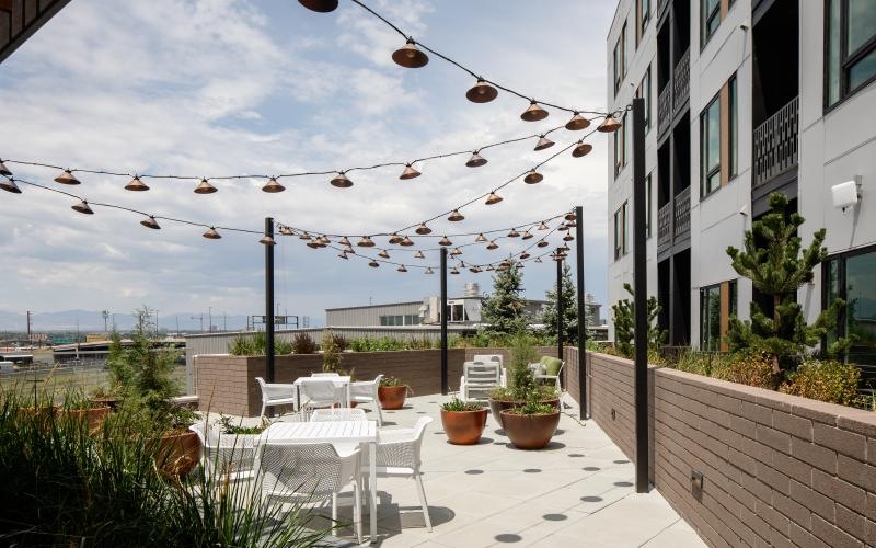 a patio with tables and chairs