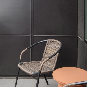 a balcony with chairs and a table